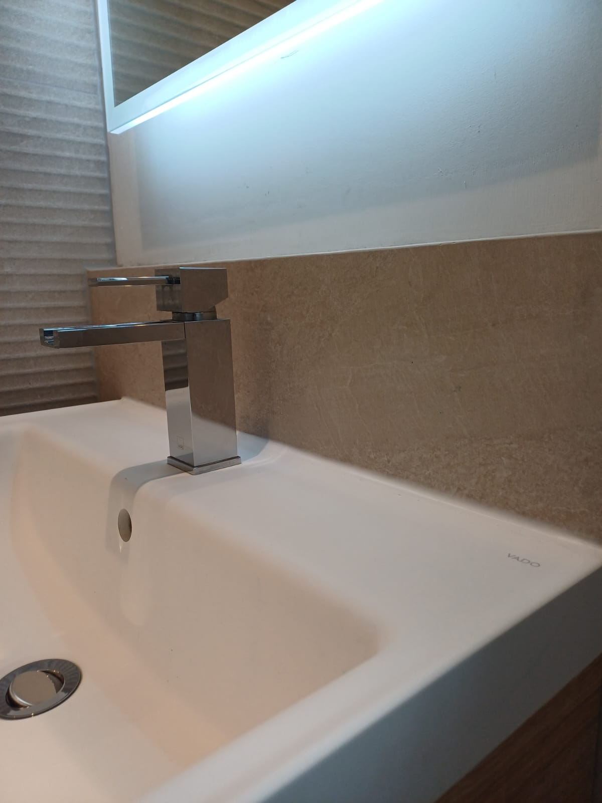 Chrome square mixer tap fitted to a new wash basin in a renovated bathroom